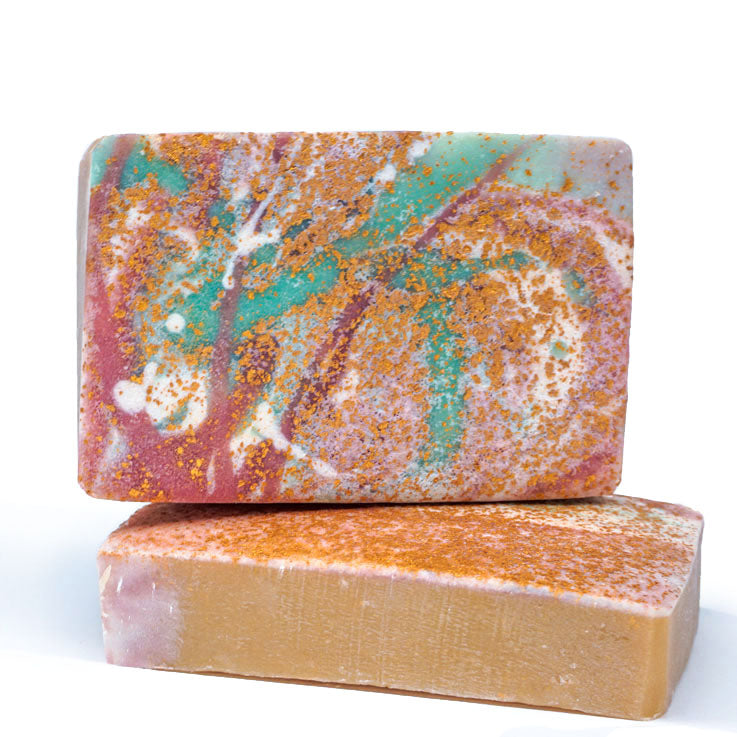 Two abstract colorful bar soaps, golden sprinkles, purple and green splatter