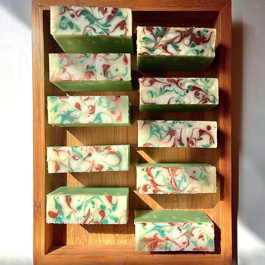 Load image into Gallery viewer, 10 jasmine green soap bars with swirly top in the bamboo plate box
