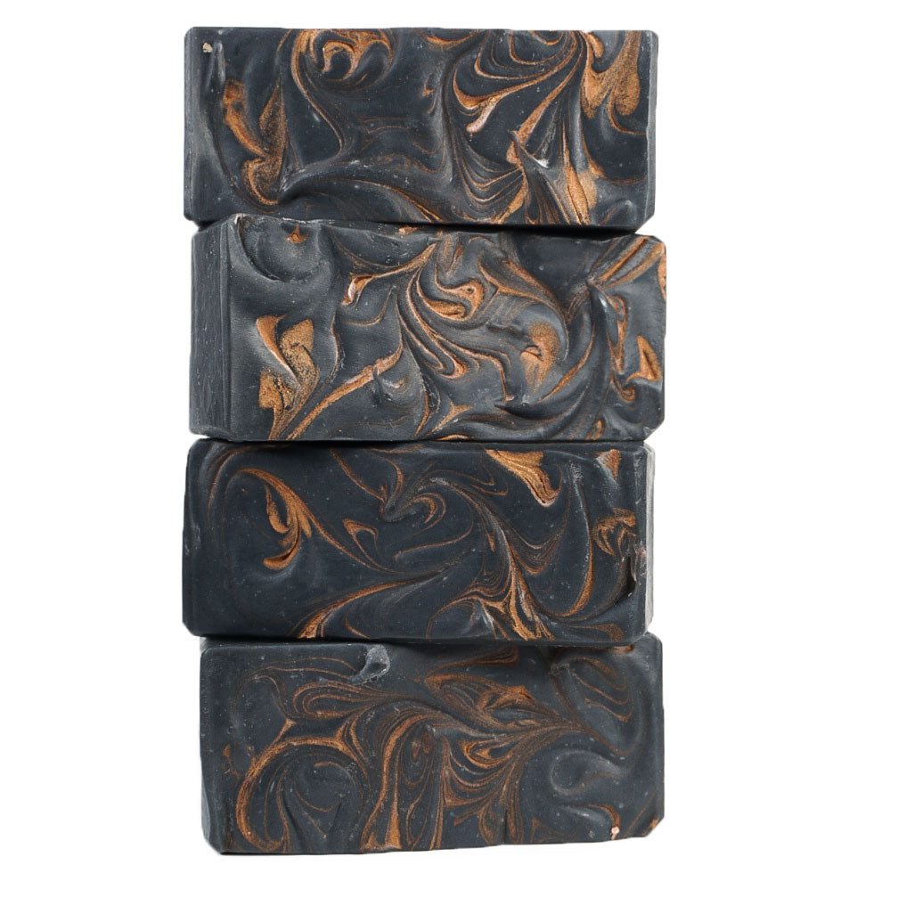 stalk of black soap bars with golden swirls