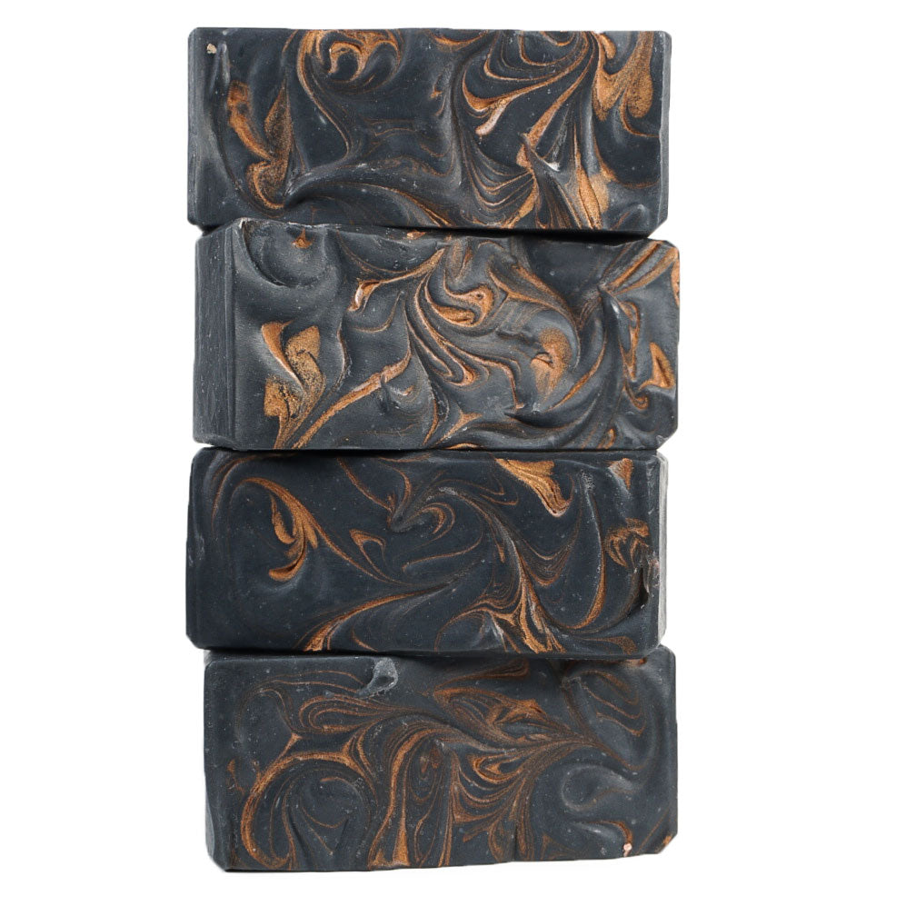 Load image into Gallery viewer, stalk of black soap bars with golden swirls
