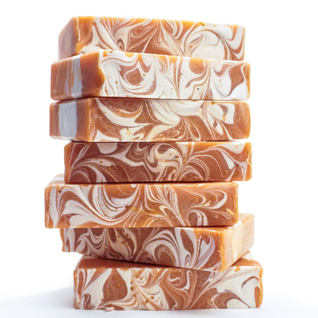 stalk of orange soap bars with white swirls on top
