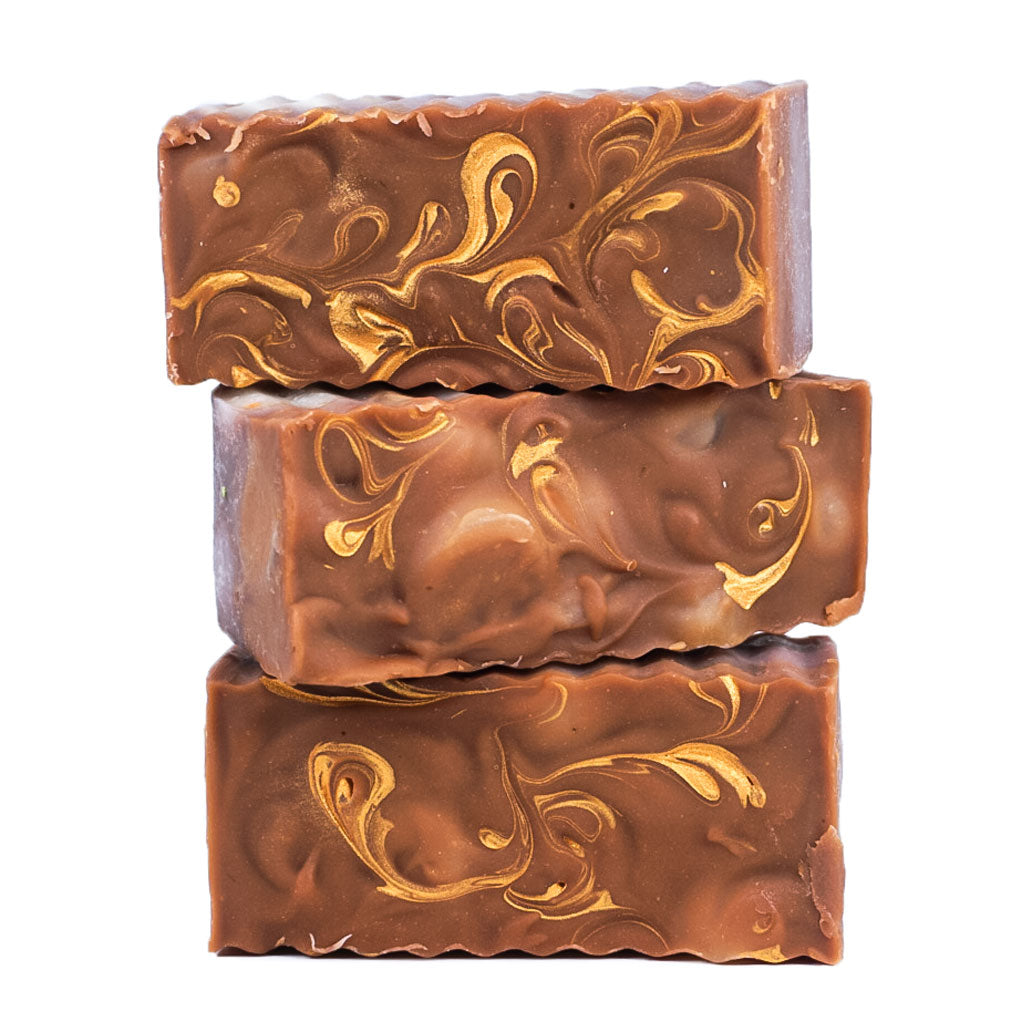 Load image into Gallery viewer, stalk of brown soap bars with golden swirls
