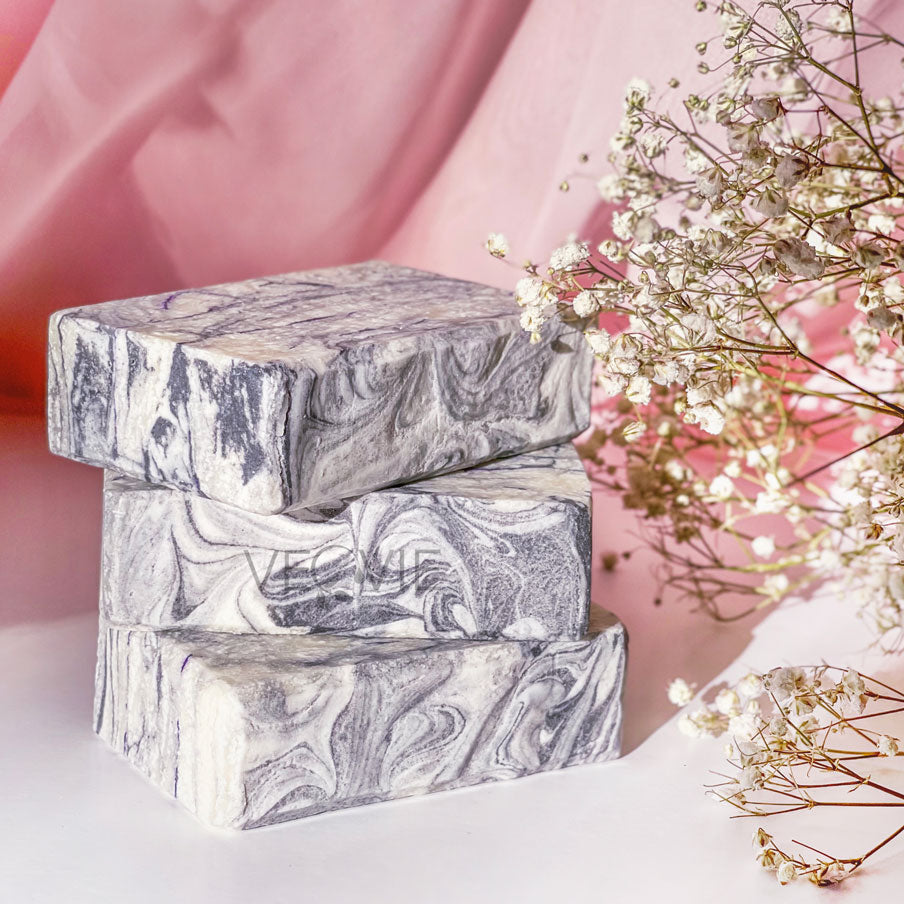 stalk of marble soap bars on a table flower in the corner